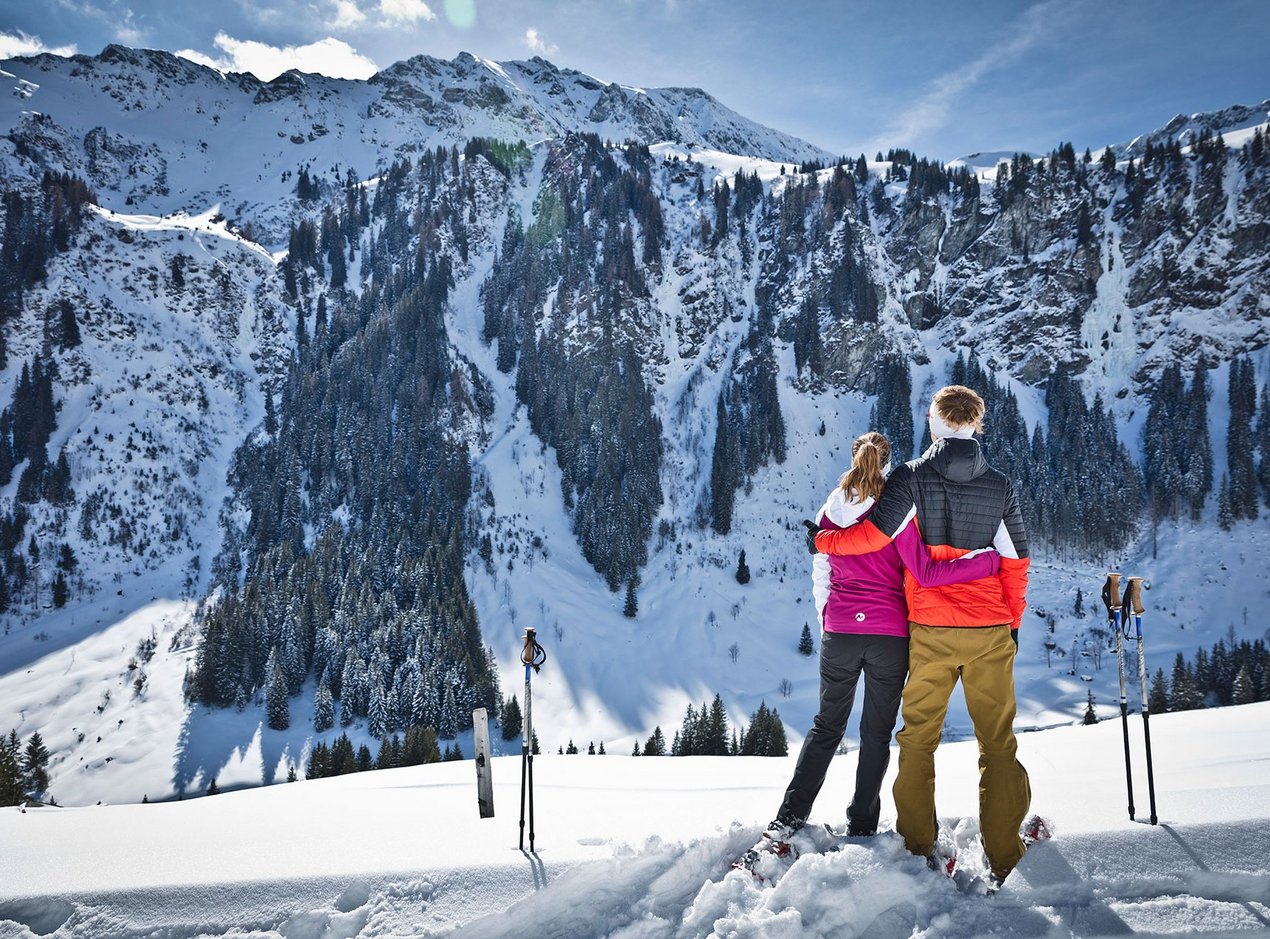 Couple snow-shoe hiking Couple snow-shoe hiking