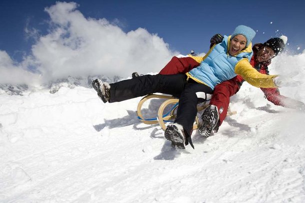 Couple tobogganing